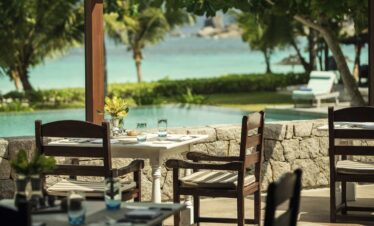 Beachfront dining at Four Seasons Resort with turquoise waters