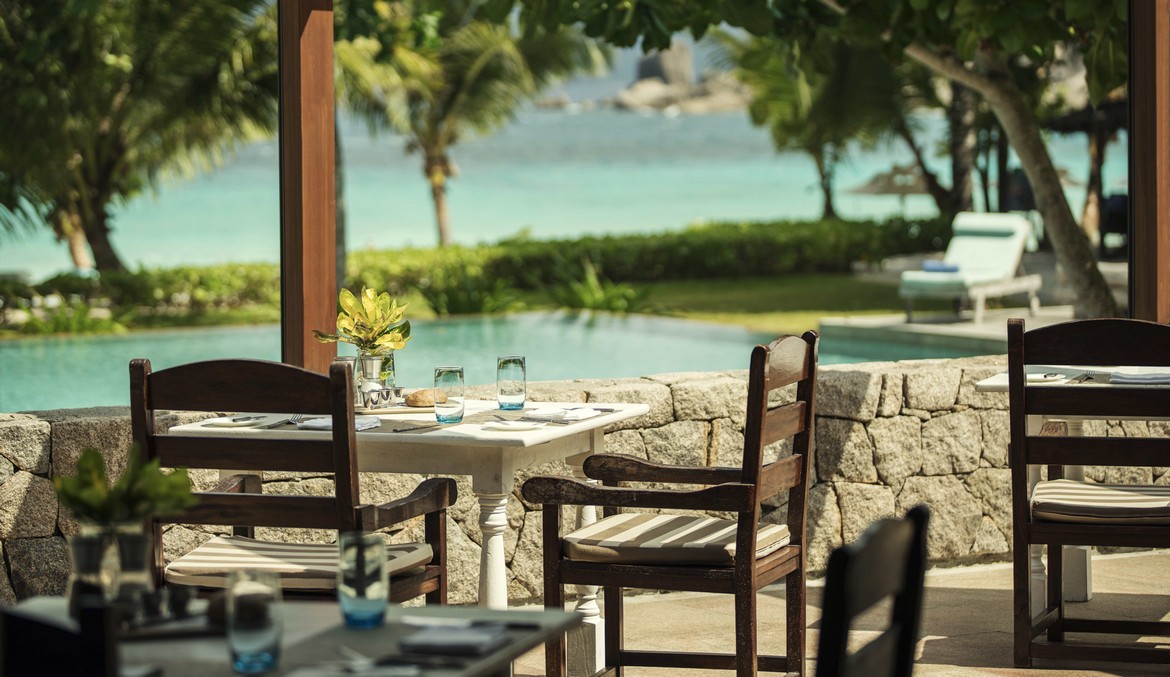 Beachfront dining at Four Seasons Resort with turquoise waters