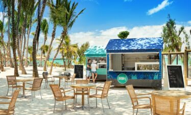 Beachfront food stall at Lagoon Attitude Mauritius with palm trees and blue sky
