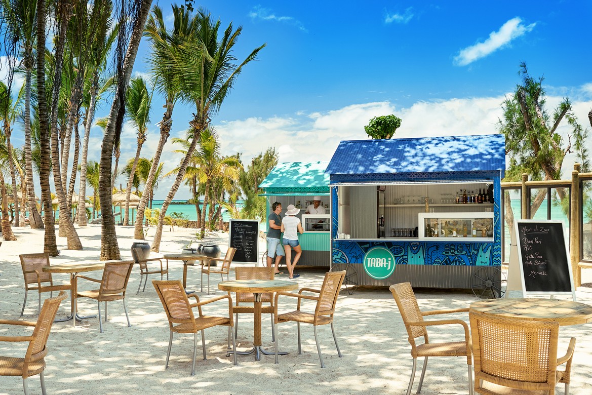 Beachfront food stall at Lagoon Attitude Mauritius with palm trees and blue sky