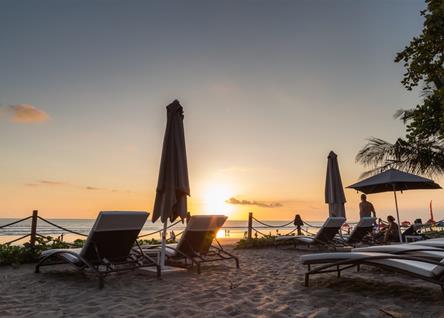 Beachfront loungers at Double Six Seminyak overlooking the sunset