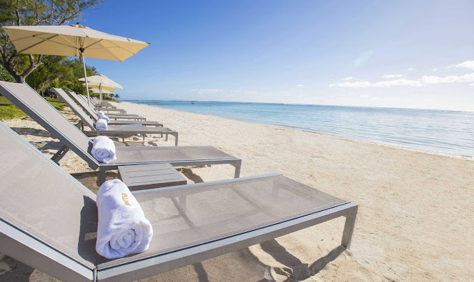 Beachfront loungers facing the ocean at Crystals Beach Resort inviting relaxation