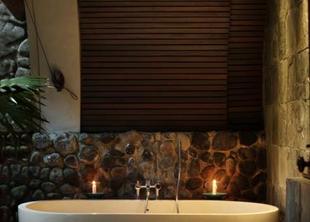 Candlelit stone bath at Alila Ubud spa retreat