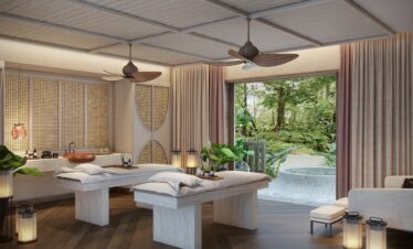 Canopy by Hilton spa room with massage tables and garden view