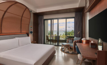 Comfortable bedroom at Canopy by Hilton with balcony and ocean view