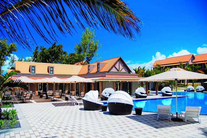 Crystals Beach Resort outdoor pool area with seating and scenic surroundings