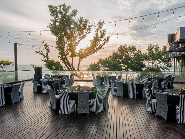 Elegant outdoor dining area at INDIGO SEMINYAK with sunset views