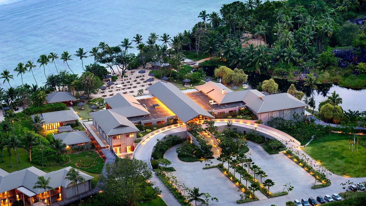 Entrance to Kempinski Seychelles Resort with lush tropical landscape