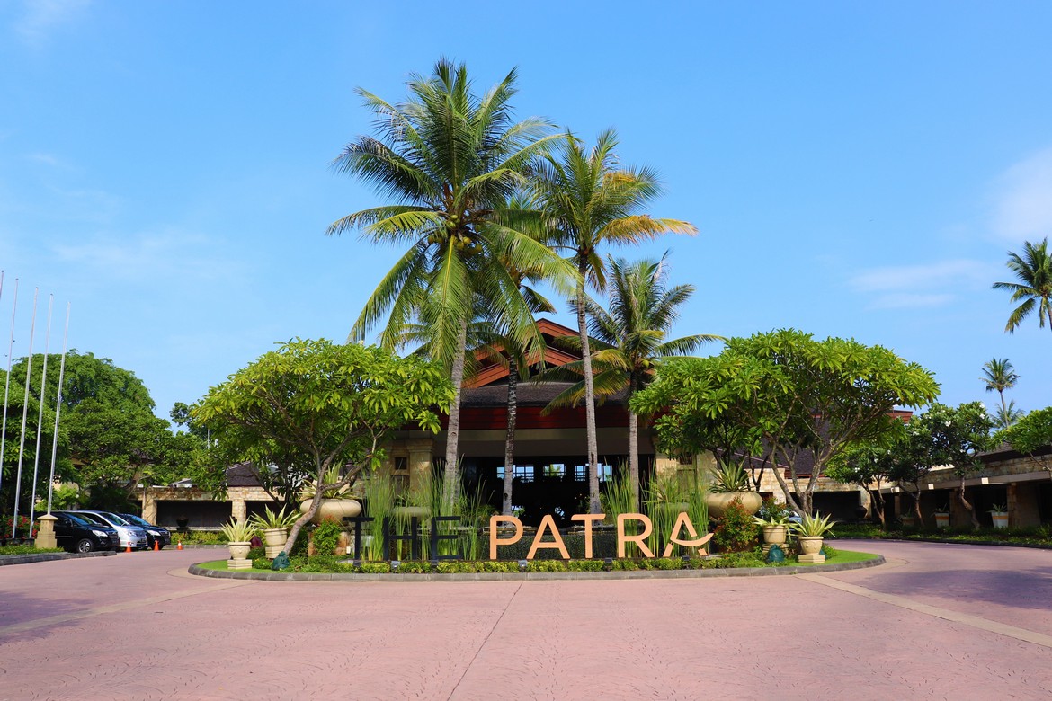 Entrance to Patra Bali Resort and Villas with tropical landscaping