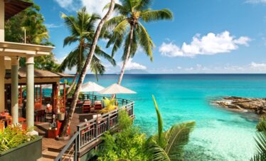 Hilton Seychelles Northolme Resort restaurant with lush tropical surroundings