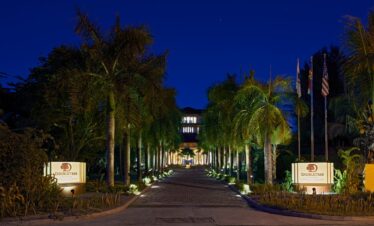 Illuminated palm-lined entrance at Doubletree by Hilton