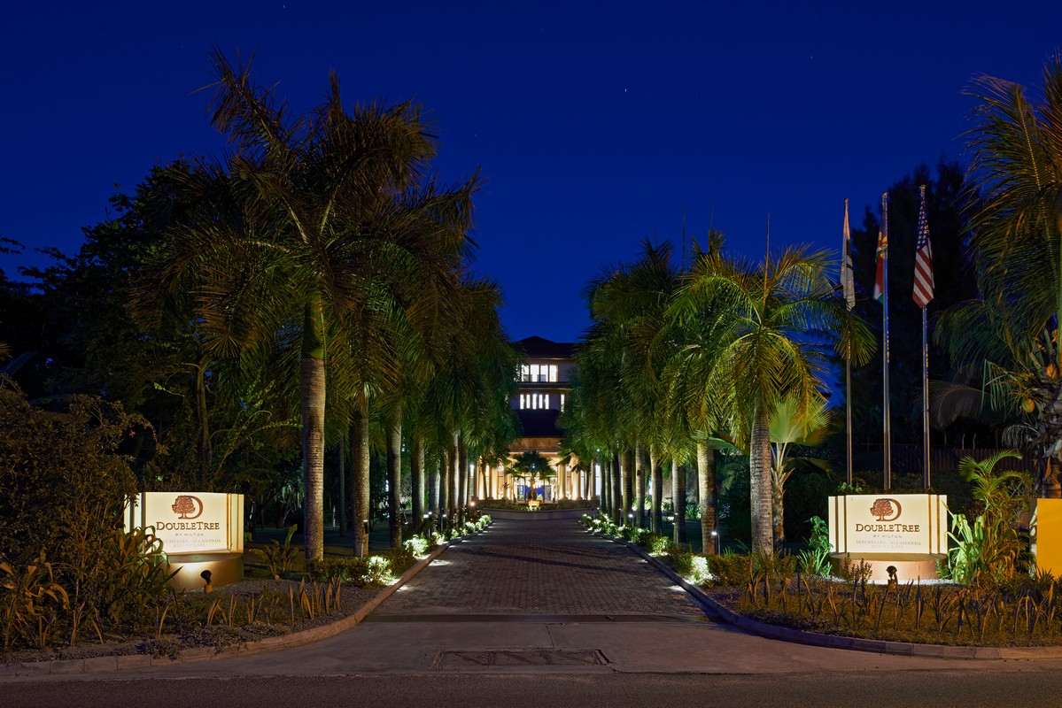Illuminated palm-lined entrance at Doubletree by Hilton