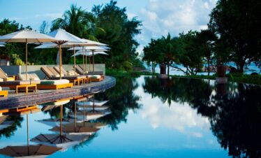 Infinity pool at Raffles Praslin reflecting the tropical sky