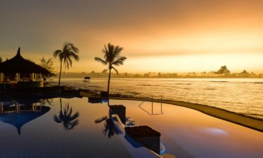 Infinity pool reflecting sunset at Nirvana At Le Meridien Ilse Mauritius for a tranquil evening swim