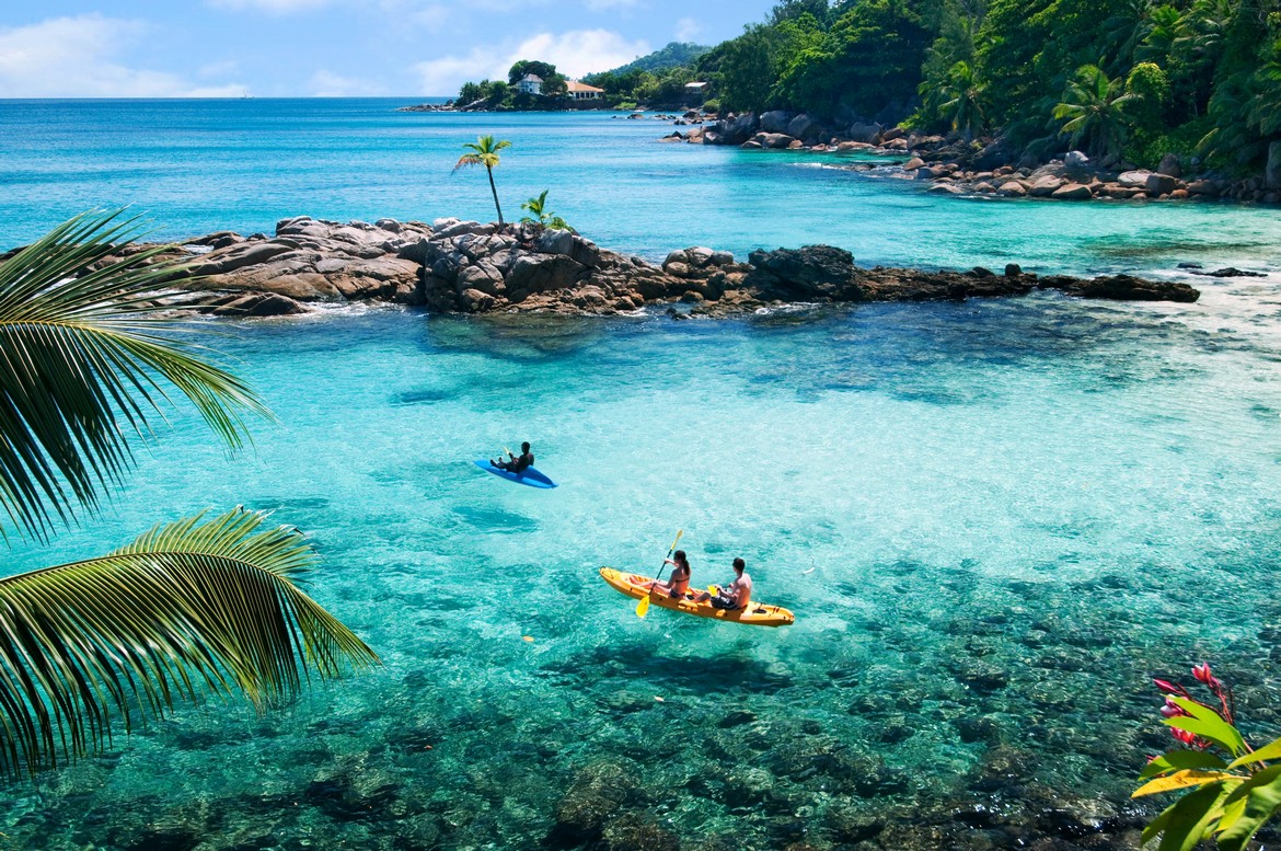 Kayaking in turquoise waters near Hilton Seychelles Northolme Resort