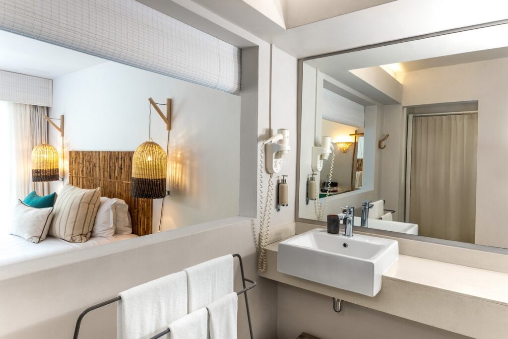 Lagoon Attitude Mauritius bedroom with bamboo decor and modern bathroom
