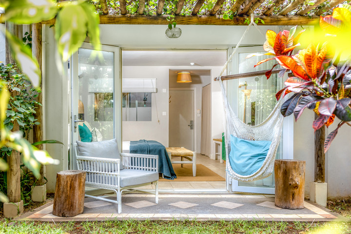 Lagoon Attitude Mauritius bungalow with hammock and outdoor seating surrounded by greenery