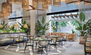 Lush dining area at Canopy by Hilton with hanging lanterns and tropical plants