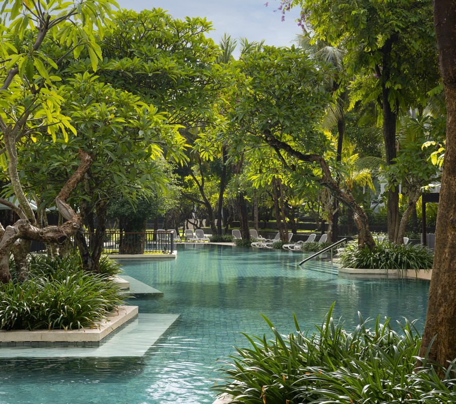 Lush pool area at The Anvaya Bali surrounded by tropical greenery