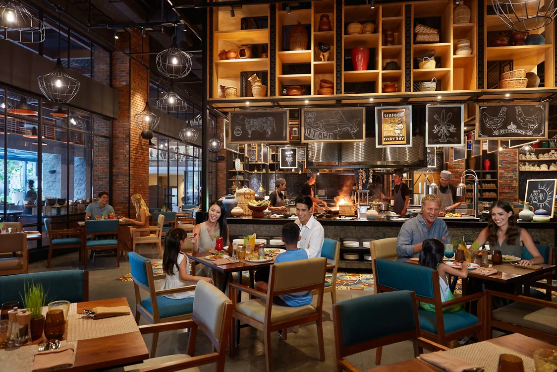 MOVENPICK JIMBARAN dining area with open kitchen and warm ambiance