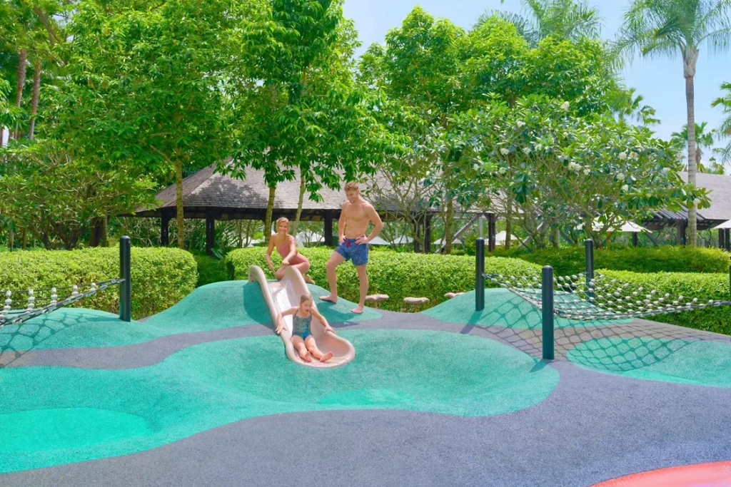MOVENPICK JIMBARAN kids playground with slides and lush tropical scenery