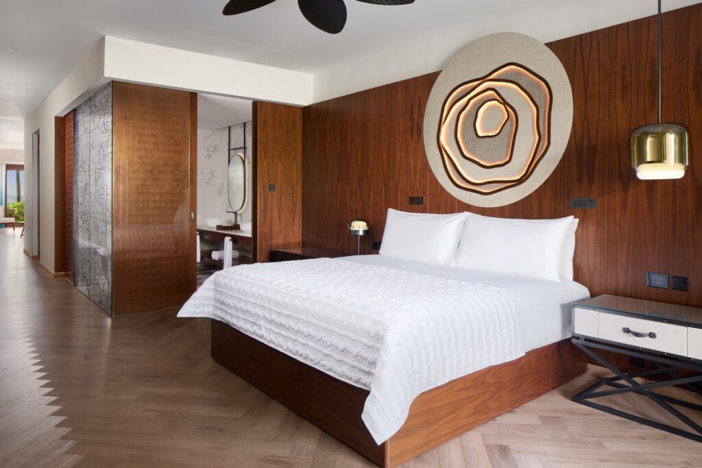 Modern bedroom interior with wooden accents at Nirvana At Le Meridien Ilse Mauritius featuring a cozy bed