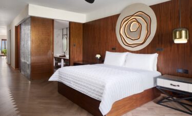 Modern bedroom interior with wooden accents at Nirvana At Le Meridien Ilse Mauritius featuring a cozy bed