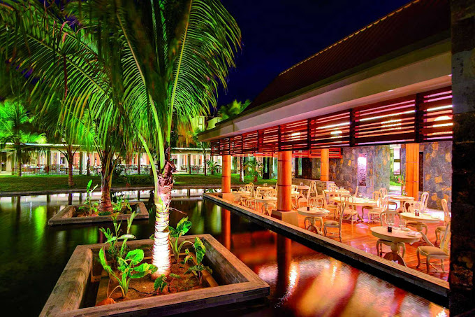 Night dining ambiance at Crystals Beach Resort near illuminated palm trees