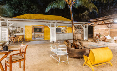 Nighttime outdoor lounge area at Lagoon Attitude Mauritius with yellow accents