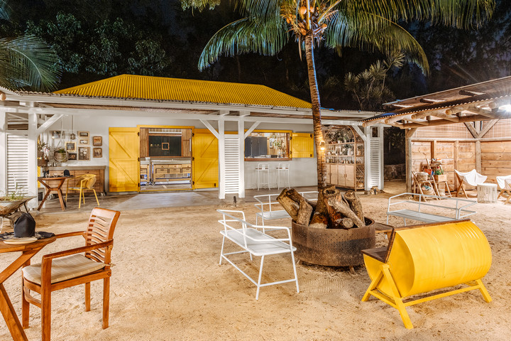 Nighttime outdoor lounge area at Lagoon Attitude Mauritius with yellow accents