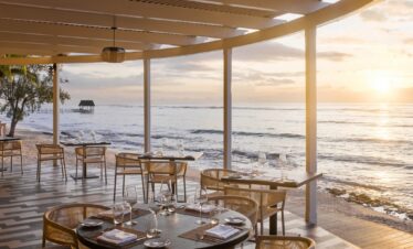 Oceanfront dining area at sunset at Nirvana At Le Meridien Ilse Mauritius offering serene views