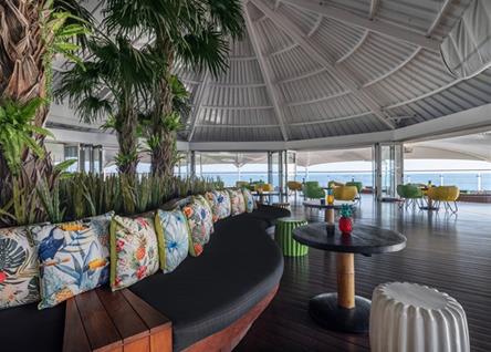 Open-air lounge at Double Six Seminyak with tropical decor and ocean views