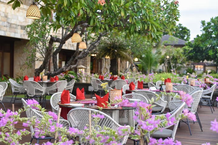 Outdoor dining at Patra Bali Resort and Villas with vibrant flowers
