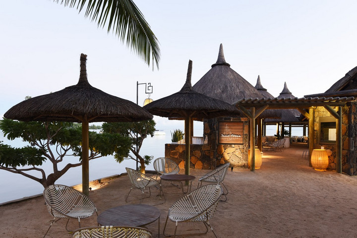 Outdoor seating area with traditional thatched umbrellas at Veranda Paul & Virginie