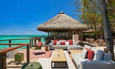 Outdoor seating by the turquoise waters at Paradise Cove Boutique