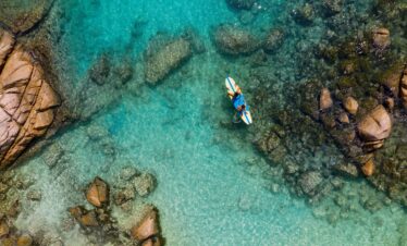 Paddleboarding in crystal waters near Raffles Praslin