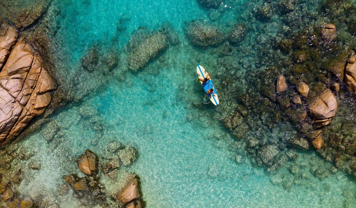 Paddleboarding in crystal waters near Raffles Praslin