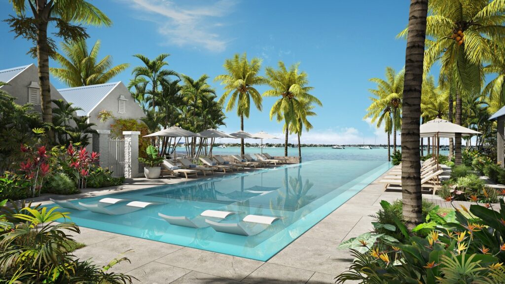 Poolside area overlooking the ocean at Veranda Grand Baie surrounded by palm trees