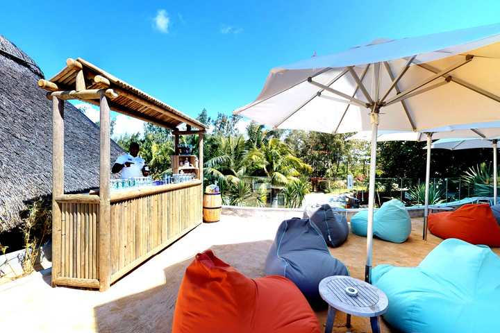 Poolside bar with bean bags and umbrellas at Radisson Blu Poste Lafayette