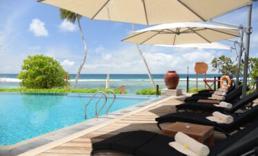 Poolside loungers at Doubletree by Hilton facing the ocean