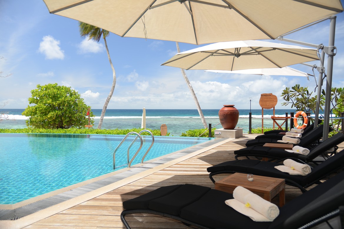 Poolside loungers at Doubletree by Hilton facing the ocean