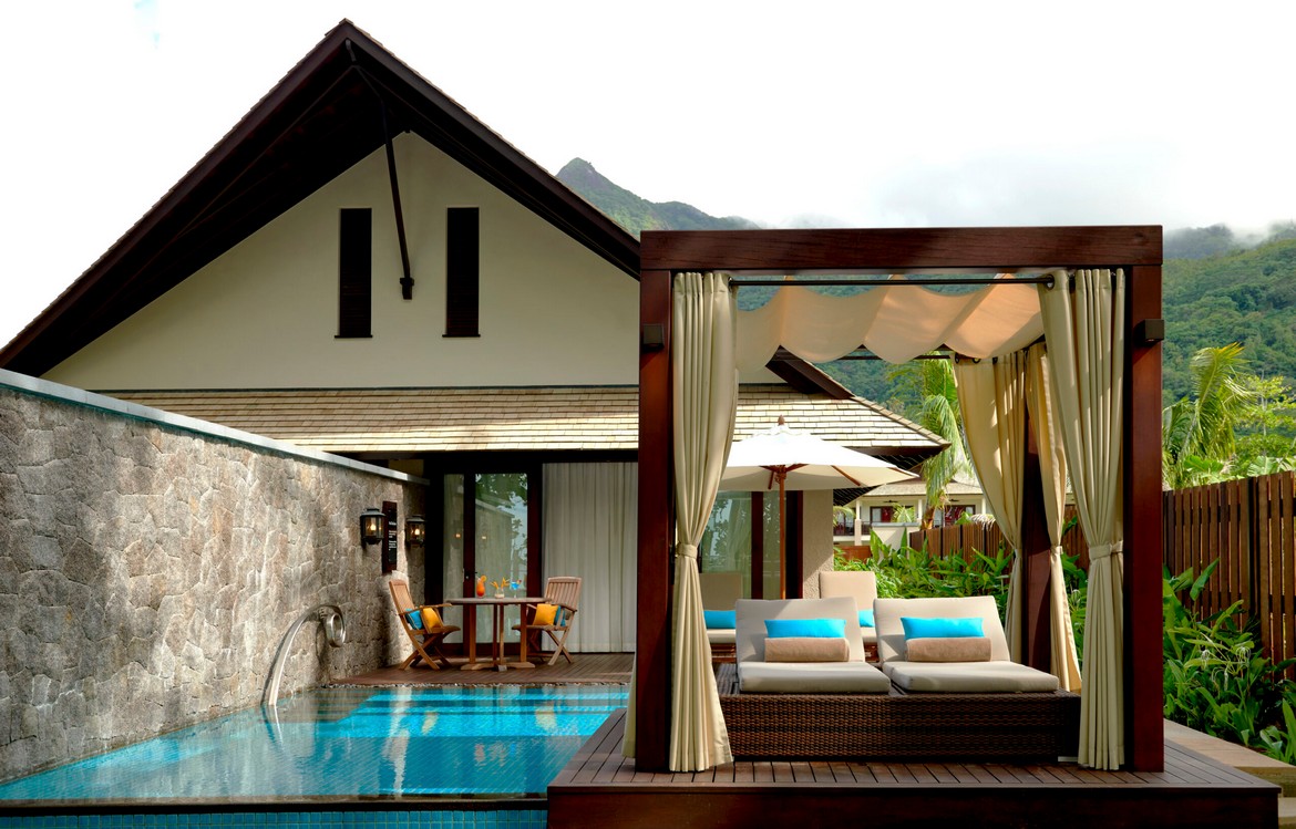 Poolside relaxation area in a resort featuring a cabana and lounge chairs Story of tranquil luxury