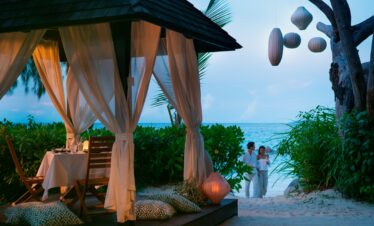 Romantic beachfront dining at Raffles Praslin under the stars