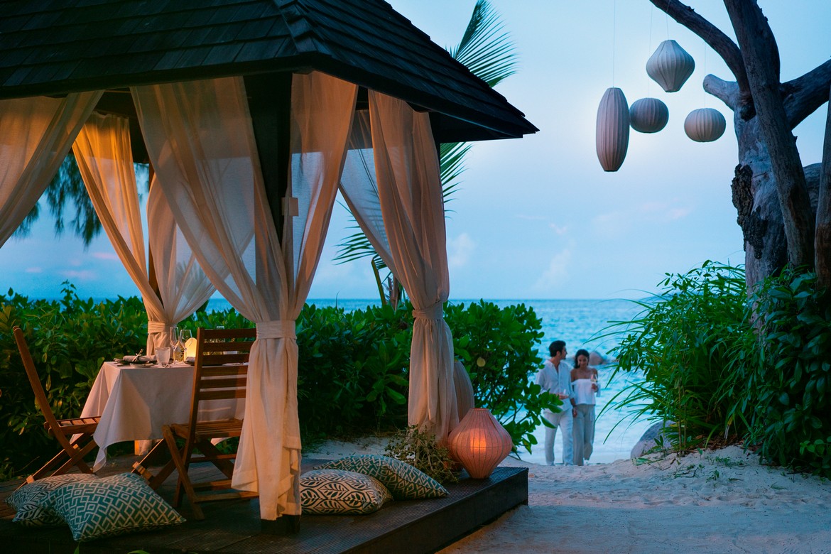 Romantic beachfront dining at Raffles Praslin under the stars