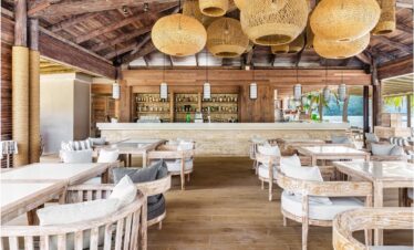 Rustic beachfront bar at Kempinski Seychelles Resort with ocean view