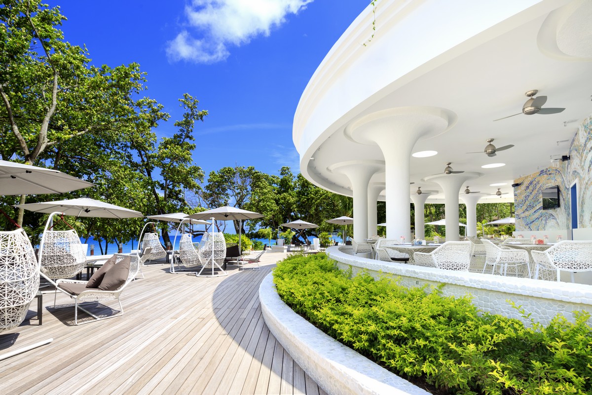 Savoy Seychelles oceanfront bar with modern white decor
