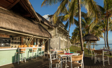 Solana Beach open-air dining area with thatched roof seating and ocean view
