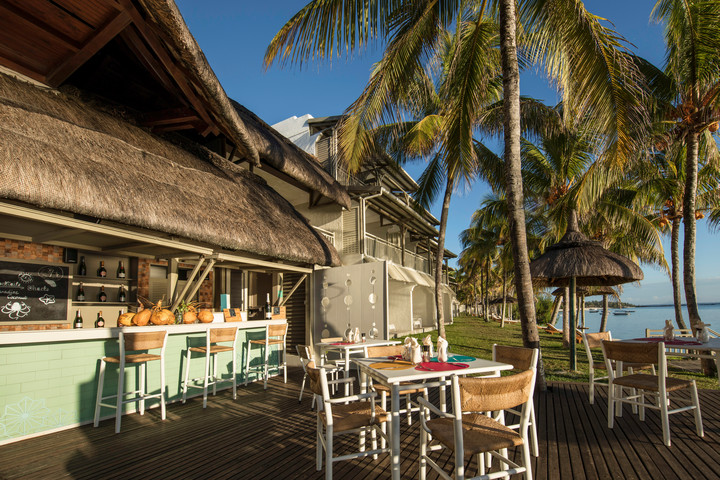 Solana Beach open-air dining area with thatched roof seating and ocean view