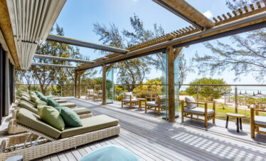 Spacious sun deck at Lagoon Attitude Mauritius with lounging chairs and ocean view