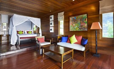 Spacious wooden suite at Hilton Seychelles Northolme Resort with canopy bed